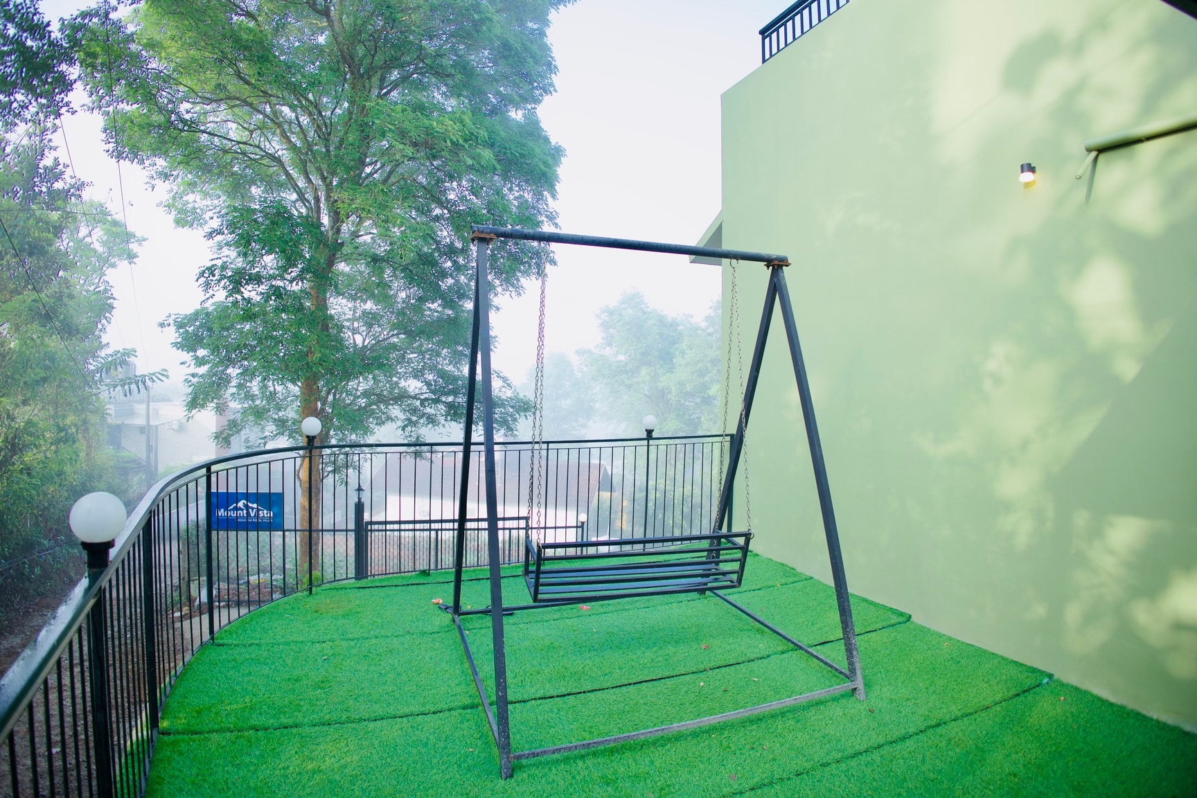 Outdoor Swing Area on Faux Grass with Foggy Morning View
